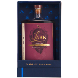 A bottle of Lark Muscat Cask Finish II Single Malt Whisky with a maroon label stands upright in an open blue box. Gold text at the bottom reads MADE OF TASMANIA, hinting at buttery raisin toast and spiced citrus notes.