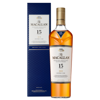 A bottle of The Macallan Double Cask 15 Year Old Single Malt Scotch Whisky stands beside its textured blue box, both featuring the brand name and whisky details, evoking rich dried fruit and creamy vanilla notes within.