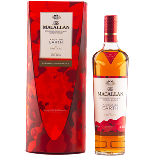 A bottle of The Macallan A Night on Earth Single Malt Scotch Whisky stands beside its matching red, gold, and purple packaging, both featuring bold abstract designs and notes of baked apple and vanilla.