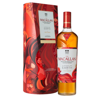 A bottle of The Macallan A Night on Earth – The First Light 2025 Release Single Malt Scotch Whisky stands beside its vibrant red and orange abstract-patterned box with gold accents, conjuring hints of toasted oak.