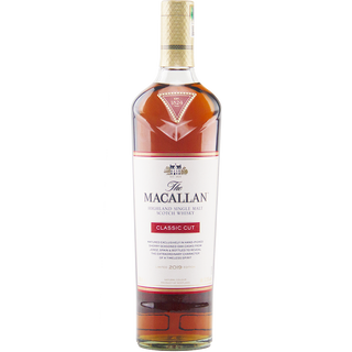 A bottle of The Macallan Classic Cut 2019 Release Single Malt Scotch Whisky, featuring a white label with red accents and a gold cap against a plain white background—renowned for oak spice notes and hints of ginger.