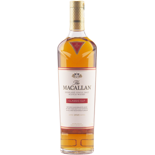 A bottle of The Macallan Classic Cut 2021 Release Single Malt Scotch Whisky features a gold cap, a red, gold, and white-accented label, and amber whisky with notes of fresh vanilla visible through clear glass.