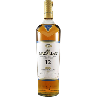 A bottle of The Macallan Triple Cask 12 Year Old Single Malt Scotch Whisky with a gold cap and white label, featuring subtle notes of citrus and vanilla.