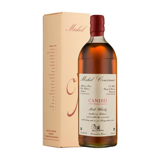 A bottle of Michel Couvreur Candid Malt French Whisky with a red cap and cream label stands before its matching light beige box, both featuring red accents and text, suggesting hints of smoky whisky and spiced fruitcake.