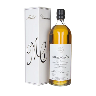 A bottle of Michel Couvreur Intravagan’za French whisky stands beside its matching white box, both adorned with elegant black script—a perfect choice for those who appreciate smooth malt and subtle orchard fruit notes.