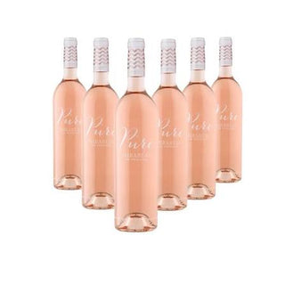 Six bottles of rosé wine arranged in a fan shape on a plain white background. The bottles are filled with pale pink liquid and have white labels with cursive text.