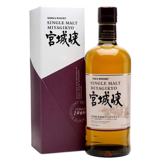 A bottle of Nikka Miyagikyo Japanese Single Malt Whisky stands beside its white and purple box adorned with Japanese and English text, its tan label reflecting gentle spice and fruity sweetness, all topped with a dark brown cap.