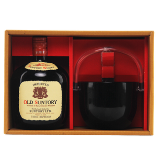 Old Suntory whiskey bottle with a glass in a wooden box