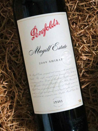 Penfolds Magill Estate 2009 Shiraz wine bottle on a straw background