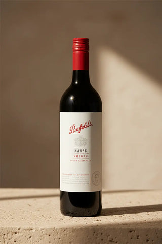 Penfolds wine bottle with a red cap on a neutral background