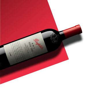 Penfolds wine bottle on a red surface