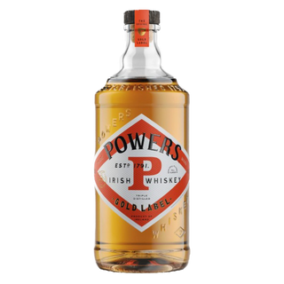 A clear bottle of Powers Gold Label Irish Whiskey, featuring a red and gold diamond label and filled with amber whiskey known for its spicy cinnamon notes, displayed against a white background.