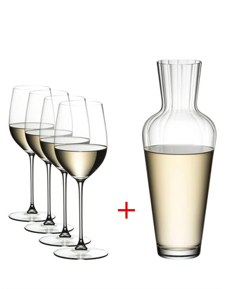 Set of wine glasses with a decanter filled with white wine on a white background