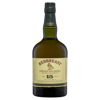 A bottle of Redbreast 15 Year Old Single Pot Still Irish Whiskey, known for its rich berry fruit and aromatic oil notes, presented in a green glass bottle with a dark cap and cream label featuring a bird illustration and gold accents.