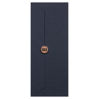 A tall, dark blue envelope with a pointed flap, sealed by a bronze sticker featuring "21", evokes the elegance of Redbreast 21 Year Old Single Pot Still Irish Whiskey—rich and nuanced like a box of tropical fruits or roasted nuts.