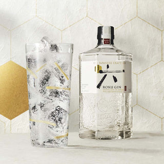 Bottle of Roku Gin with a glass of tonic water on a decorative background