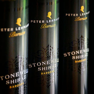 Three dark glass bottles of Peter Lehmann Barossa Stonewell Shiraz lined up closely, showing the black labels with gold and white typography.