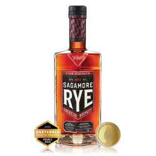 A bottle of Sagamore Spirit Cask Strength American Rye Whiskey with a red and black cap, featuring two gold award medals in front. The label highlights notes of spicy rye and hints of roasted hazelnuts.