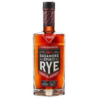 A bottle of Sagamore Spirit Cask Strength American Rye Whiskey features an amber hue. Its red and black label with bold white text suggests tasting notes of spicy rye and dark chocolate.