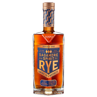 A bottle of Sagamore Spirit Double Oak American Rye Whiskey with a copper cap and blue-copper label, featuring amber whiskey with notes of creamy toffee and toasted coconut.