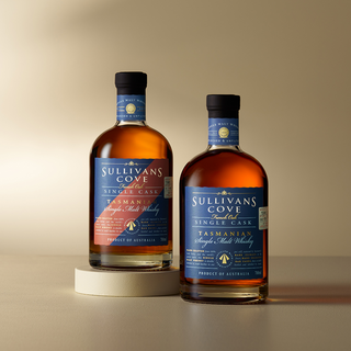Two bottles of Sullivans Cove Tasmanian Single Malt Whisky on a beige background