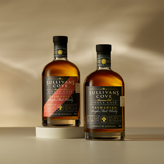 Two bottles of Sullivans Cove 15 Year Old American Oak ex-Bourbon TD0327 Single Malt Whisky with black labels and gold and red accents are displayed on a light surface, one slightly raised on a round platform.