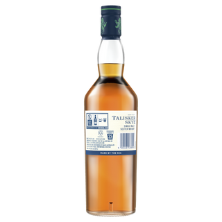 A bottle of Talisker Skye Single Malt Scotch Whisky seen from the back displays its label with product details and recycling symbols. The amber spirit embodies "Made by the Sea" with notes of coastal brine and light peat smoke.