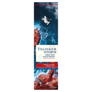 The front of the Talisker Storm Single Malt Scotch Whisky box shows waves crashing on a rocky coast, reflecting this peated whisky’s maritime essence with “Made by the Sea” and bold blue-and-white branding.