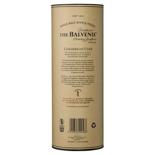 Tall cylindrical container of The Balvenie Caribbean Cask 14 Year Old Single Malt Scotch Whisky with tan and gold labeling. Text highlights tropical notes, toffee, and vanilla. Branding and product description are above the barcode.