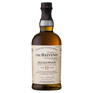 A bottle of The Balvenie DoubleWood 12 Year Old Single Malt Scotch Whisky, matured in oak and sherry casks, with a beige label and dark brown cap, is shown against a plain white background.