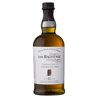 A bottle of The Balvenie Stories The Sweet Toast of American Oak 12 Year Old Single Malt Scotch Whisky shows tan liquid inside a clear bottle, featuring vanilla and oak spice notes, with a dark cap and detailed front label.