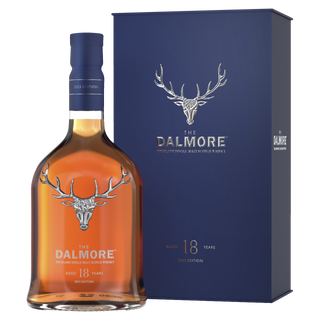 A bottle of The Dalmore 18 Year Old Single Malt Scotch Whisky stands before its blue box, both adorned with a silver stag logo and elegant silver lettering—suggesting hints of spiced gingerbread and chocolate raisins.
