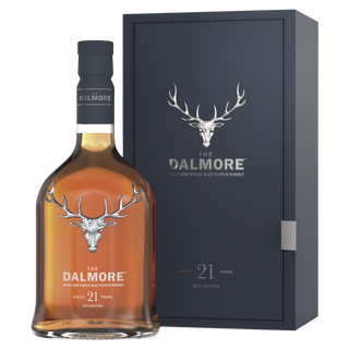 A bottle of The Dalmore 21 Year Old Single Malt Scotch Whisky stands before its matching dark blue box, both adorned with a silver stag logo and white text—ideal for those who enjoy rich dark chocolate notes in their whisky.