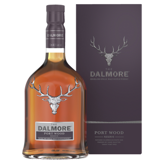 A bottle of The Dalmore Port Wood Reserve Single Malt Scotch Whisky stands by its purple box, both with a silver stag logo and elegant silver lettering, suggesting flavors of sweet berries and creamy caramel.