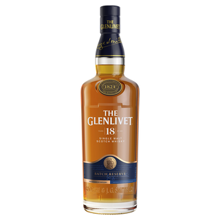 A bottle of The Glenlivet 18 Year Old Batch Reserve Single Malt Whisky features gold, navy, and white labeling with a blue cap and gold medallion. This whisky has a rich amber hue and offers aromatic hints of warm spices.