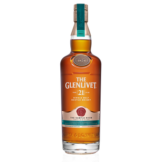 A bottle of The Glenlivet 21 Year Old Single Malt Scotch Whisky with a teal and gold label stands upright on a white background, suggesting notes of warm spices and rich oak.