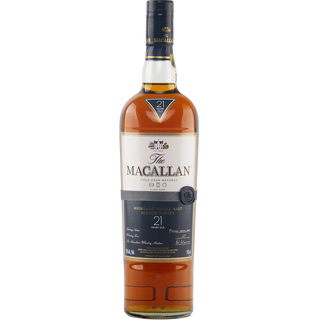 A bottle of The Macallan 21 Year Old Fine Oak Single Malt Whisky with a dark cap and black label with gold and white text. The amber whisky inside delivers subtle sherry and vanilla notes.