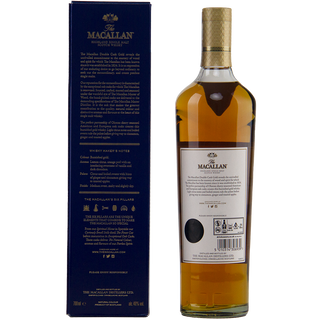 A bottle of The Macallan Double Cask Gold Single Malt Scotch Whisky stands beside its navy blue box, displaying the back label and gold cap. The box showcases gold writing and detailed product information.