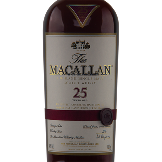 A close-up of a 700ml bottle of The Macallan 25 Year Old Sherry Oak Single Malt Scotch Whisky (Pre-2018), showcasing a gold and maroon label with a detailed maroon ribbon seal, renowned for sherry-soaked raisin and wood spice notes.