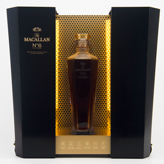 The Macallan whisky bottle in a black and gold box on a white background