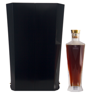 Bottle of Brugal 1888 rum next to a black geometric sculpture on a white background