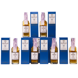Multiple bottles and boxes of The Macallan whiskey on a white background