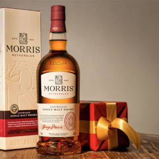 A bottle of Morris Signature Australian Single Malt Whisky stands beside its box, evoking rich notes of cherry jam and dark chocolate.
