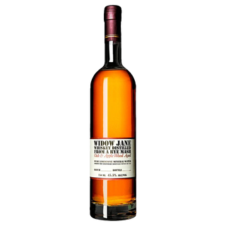 A bottle of Widow Jane American Oak and Apple Wood Aged Rye Whiskey, amber-hued with a white label in black and red text, is showcased against a plain white background, highlighting rich caramel and toasted oak notes.