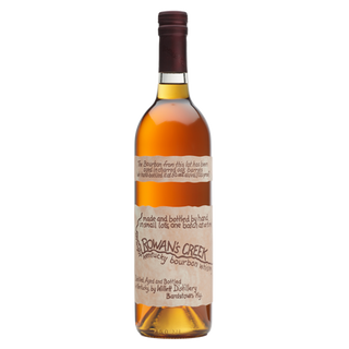 A bottle of Willett Family Estate Rowan’s Creek Small Batch Bourbon Whiskey stands upright against a white background, its tan handwritten-style label and amber liquid suggesting floral vanilla notes.