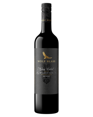 A bottle of Wolf Blass Grey Label Shiraz red wine, featuring a dark grey label with a gold eagle logo and white text, set against a plain white background.