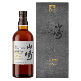 Yamazaki whisky bottle and packaging on a green background
