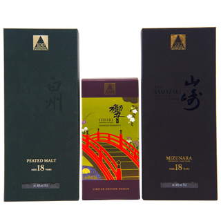 Three boxes of Luffa 100 Years Old Japanese Whisky on a white background: a dark green Peated Malt 18 Year box on the left, a central limited edition box with a red bridge illustration, and a dark Mizunara 18 Year box on the right.