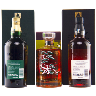 Three bottles of Suntory whisky displayed together against a white background, including a dark bottle with a green label, a clear bottle with a decorative tree design, and a dark bottle with a white label.