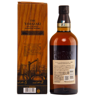 Yamazaki whisky bottle and wooden box on a white background